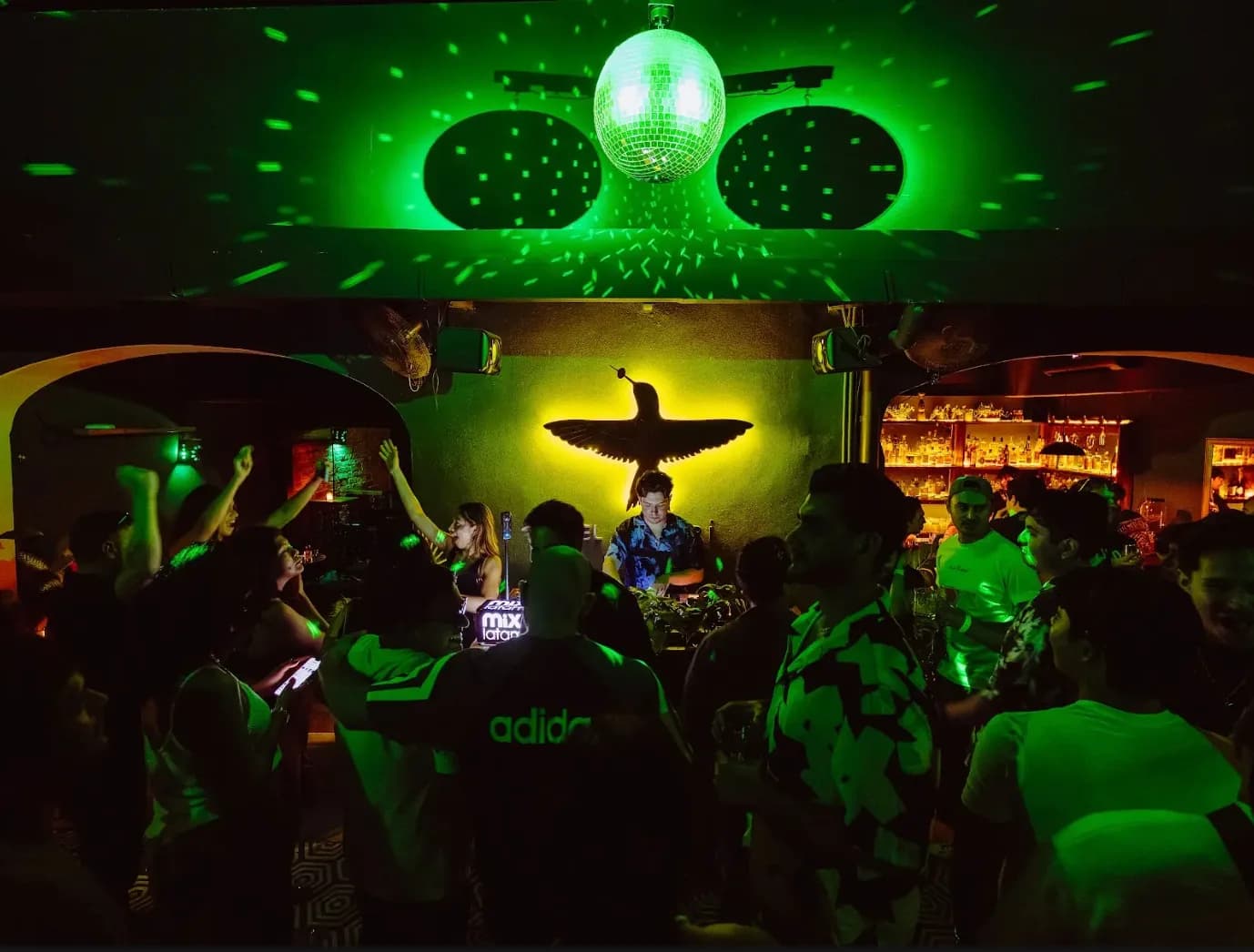 Nightlife bar with green lights and disco ball from SYPA’s existing portfolio